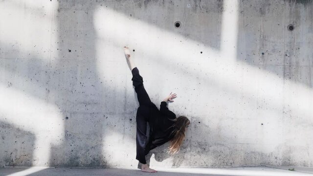 Shadow ballet dance form practice at a grungy wall