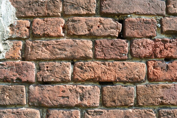 Old weathered Broken Brick wall fragment .