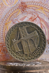 Close-up of English coins against the background of fragments of a 10 pound note