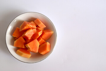 A bowl fresh papaya isolated on white background