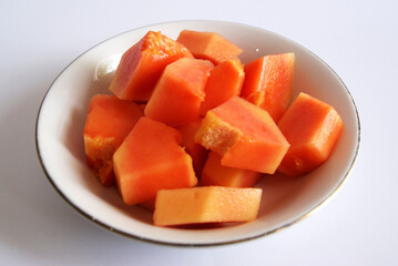 A bowl fresh papaya isolated on whote background. Close up photo of papaya.