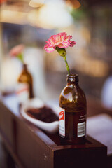 Cut Pink and White Carnations in Beer Bottles at Restaurant