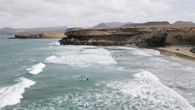 Aerial drone view of Viejo Rey Beach in Fuerteventura with surfers