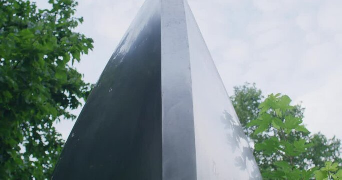 Close up shot of a metal structure between trees and bushes. Parallax camera shot with deep depth of field.