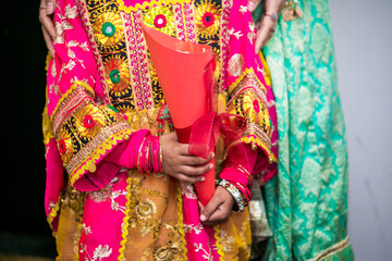 Indian bridesmaids' hands holding petals close up