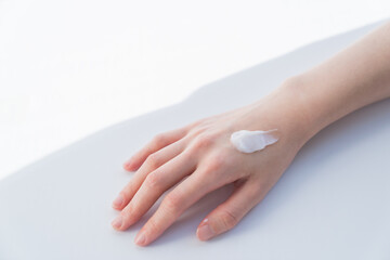 woman applying cream on her hand