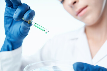 Fototapeta premium woman with blue gloves laboratory research science