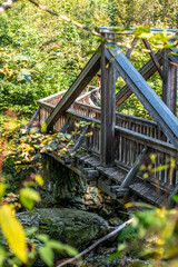Old wooden bridge "Teufelssteg" over a river with rocks in Höllental Upper Franconia