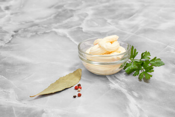 Glass bowl with cheese sauce on kitchen table.