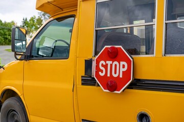 Mini school bus with stop sign on side 