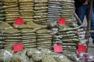East market. Various spices on the counter at the seller are exhibited for sale. Packaged in bags...