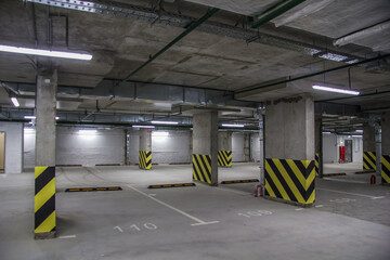 Empty parking place in a residential building. Covered underground parking for cars