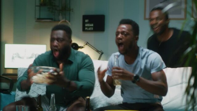 Anxious black fans watching competition and celebrating victory