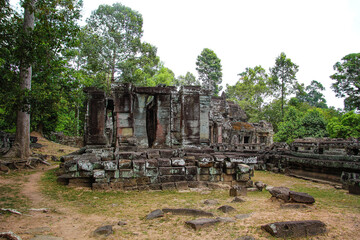 Fototapeta na wymiar Cambodia Ta Prohm famous jungle embracing temples, revenge of nature against human buildings. Angkor thom complex at Siem Reap