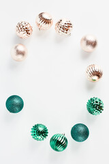 holiday Christmas frame of toys in the shape of a ball of green and gold color on a white background. top view with place for text