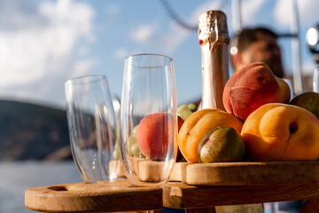 Fruit tray and bottle of champagne for romantic date on a yacht