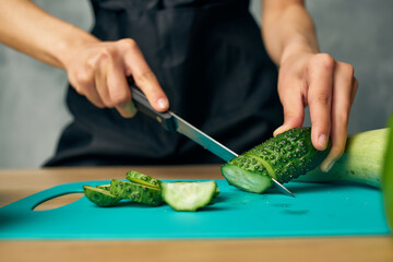 woman on the kitchen cutting vegetables salad