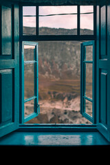 window with blue shutters with mountain view