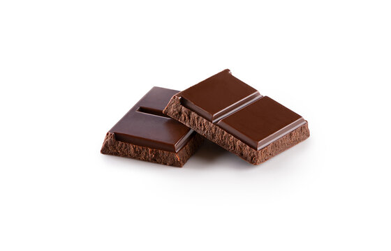 pieces of smooth chocolate bar lying on top of each other close-up isolated on white background 
