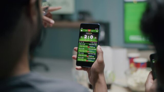 Crop men making bets during soccer match