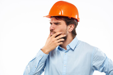 emotional man orange helmet on the head Studio hand gesture