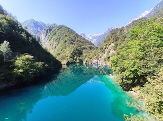 Naklejka na ściany i meble Scenic view of the Mis Lake (Lago del Mis) with its blue water, in the Dolomiti Bellunesi National Park, Sospirolo, Belluno