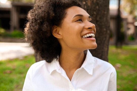 A cute young woman spending time in the park and looking contented