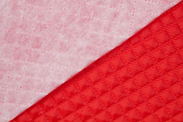 Quilted fabric. The texture of the blanket. Red textiles	
