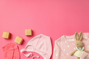 Concept of female baby clothes on pink background