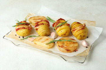 Concept of tasty food with baked potato on white textured background