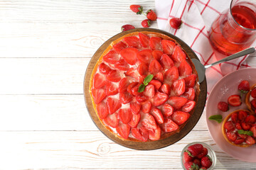 Concept of tasty food with strawberry tart on white wooden background
