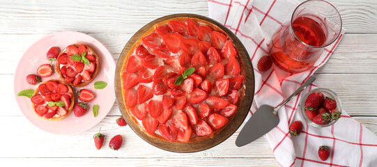 Concept of tasty food with strawberry tart on white wooden background