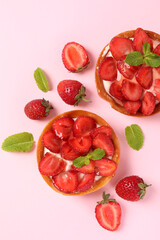 Strawberry tarts on pink background, top view