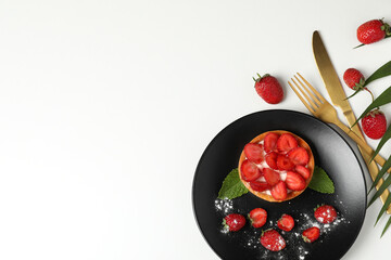 Concept of tasty food with strawberry tart on white background