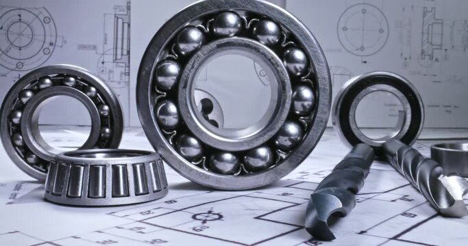 Mechanical diagrams, bearings and drills. Mechanical parts on designer desk.