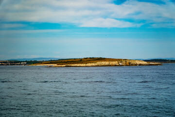 seascape, shore going into the sea, azure sea water, beautiful clouds over the sea 