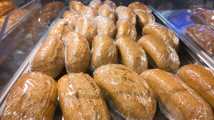 Rye grain buns on bakery showcase
