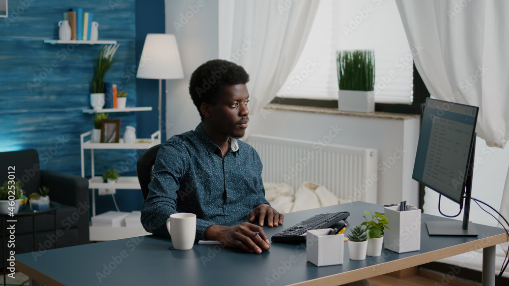 Aufkleber black african american freelancer taking notes on notepad and looking into computer, remote working 