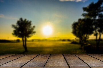 Wooden table and blur of beauty on sunny day on rice field with sky and mountains as background..