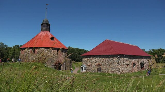 A front view of the Museum fortress korela with blue sky and green shrubs, Russia.