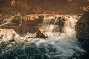 A rapid river flow formed a threshold and a small waterfall on the stream. Concept of a clean...