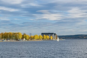 A white sailboat enters the marina in the center of Östersund - 460256425