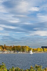 A white sailboat enters the marina in the center of Östersund - 460256440