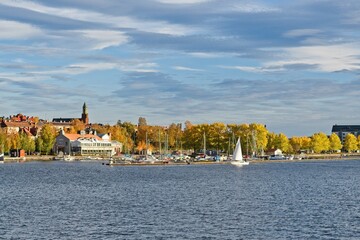A white sailboat enters the marina in the center of Östersund - 460256442