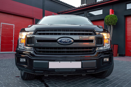 Ukraine, Odessa July 8 - 2021: Black Ford Raptor suv xtr 4x4 truck pickup on the parking. Front view