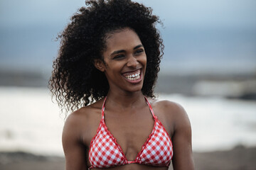 Woman in bikini in a volcanic beach