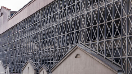 Car parking building with metal grille. Abstract steel surface with copy space. Urban concept.