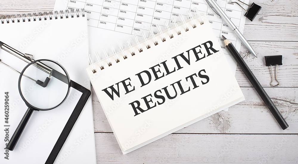 Poster we deliver results text written on notepad with office tools and documents.