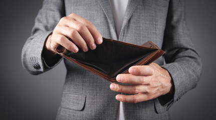 Businessman showing empty wallet. Bankruptcy