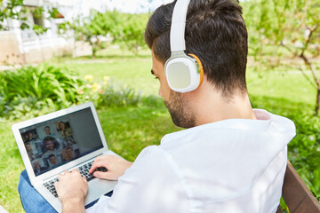 Freelancer beim Videochat am Laptop PC im Garten